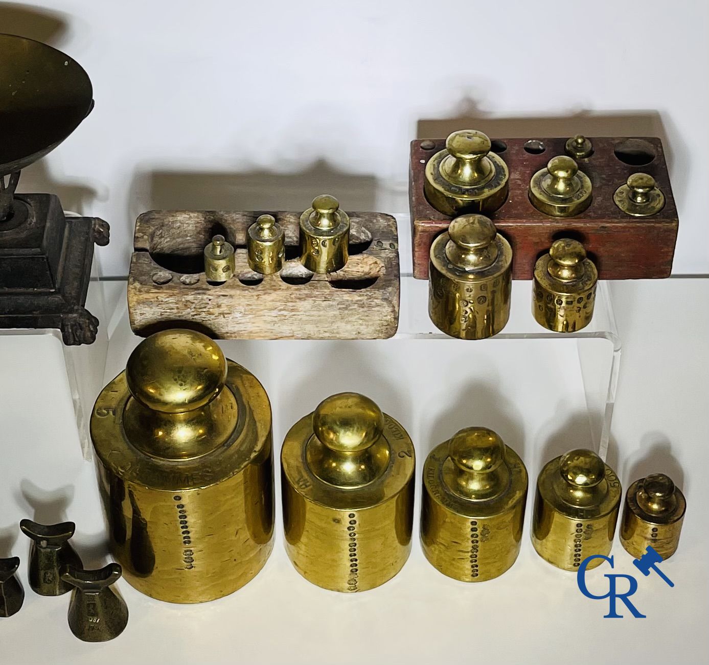 A various lot of antique calibration weights and a calibrated scale. 18th-19th century.