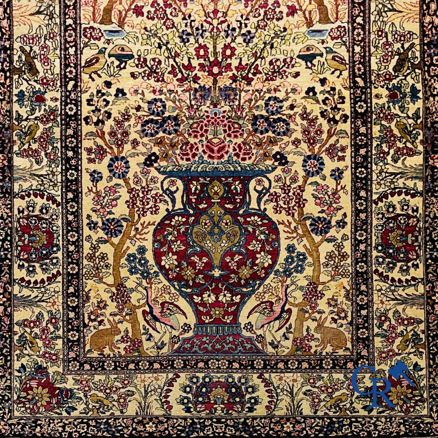Oriental carpets. Iran. Persian carpet with a flower vase, birds and rabbits in a floral decor.