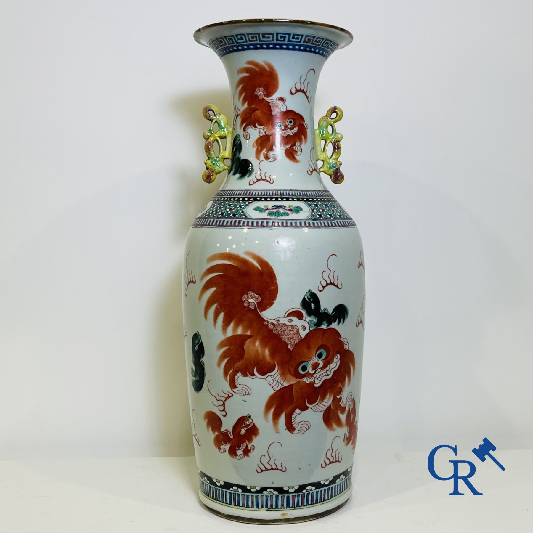 Chinese porcelain: A Chinese famille rose vase with a decor of Buddhist lions, phoenixes, birds and peonies.