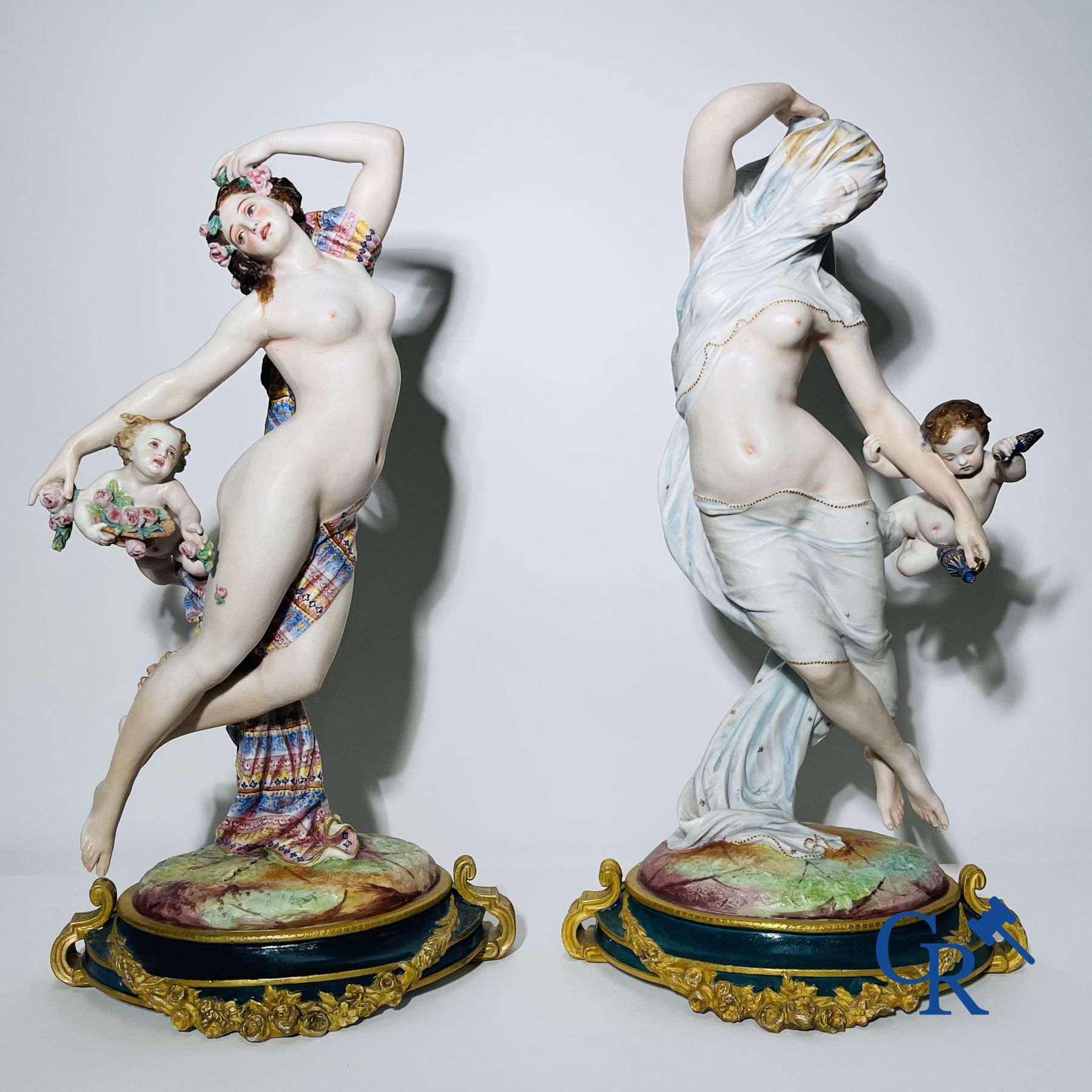 Porcelain: Large pair of multi-coloured decorated and gilded statues in biscuit with the representation of "Day and Night".