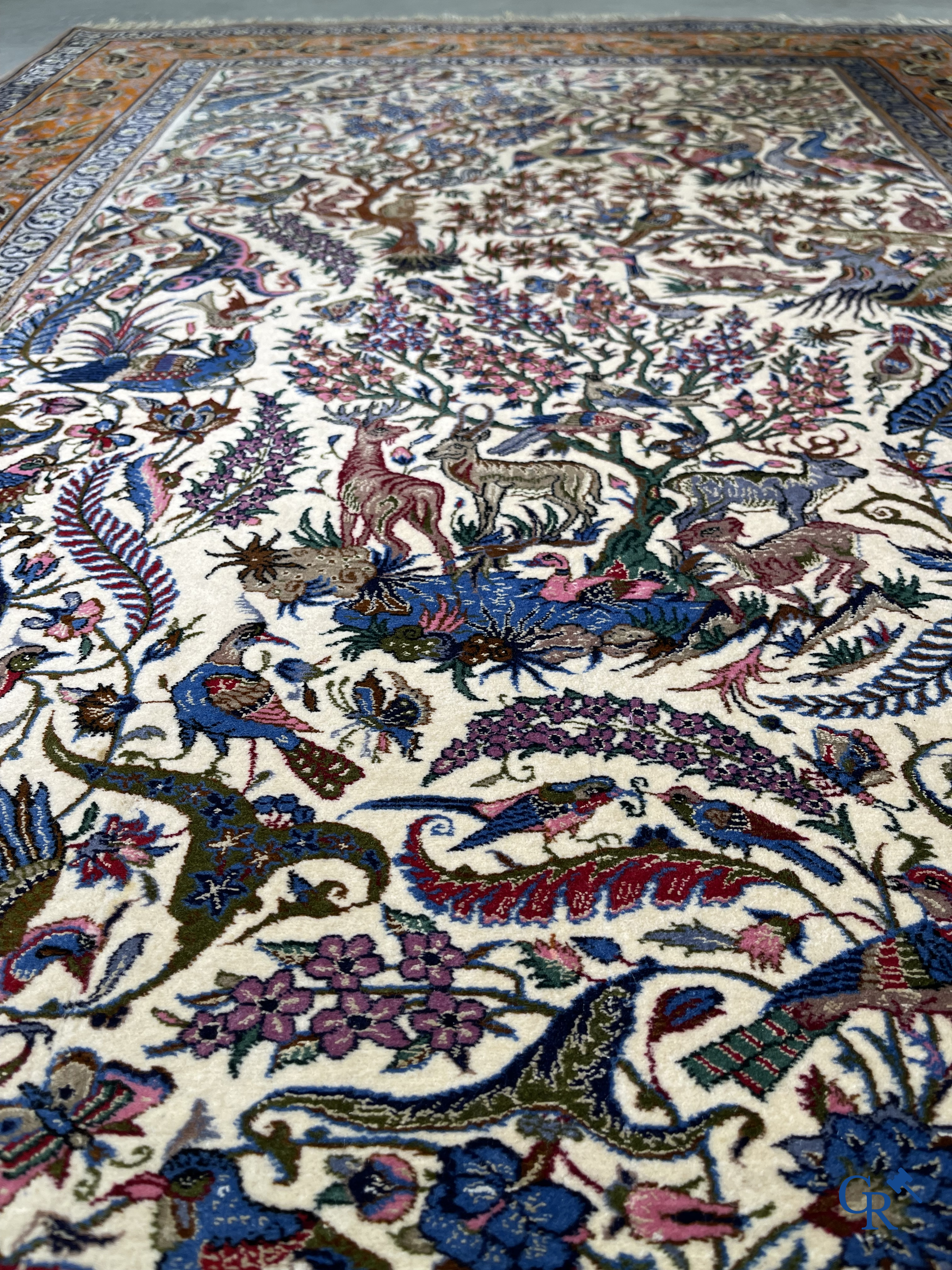 Oriental carpets, a finely hand-knotted silk carpet with forest animals. Signed.