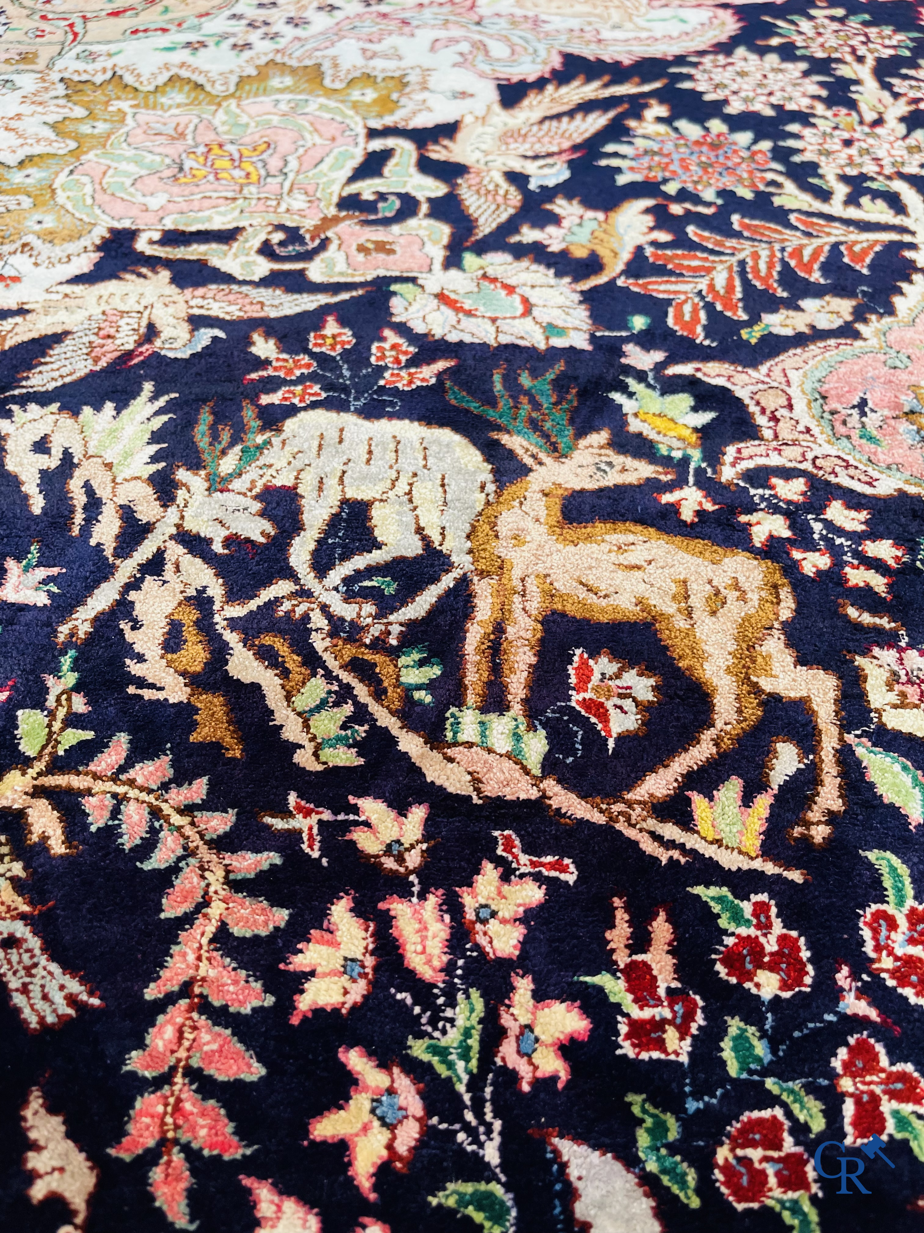 Oriental carpets: Tabriz, a finely hand-knotted silk carpet with forest animals and birds in a floral decor.